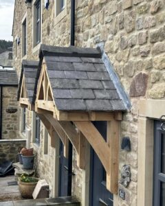 Timber-framed porch structures on traditional stone houses.