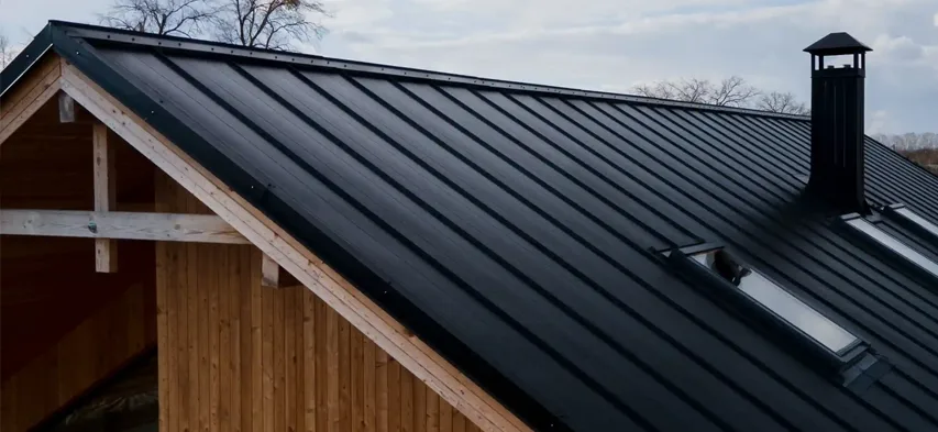 Aerial view of a newly installed tin roof on an old building by Drivers Building & Roofing.